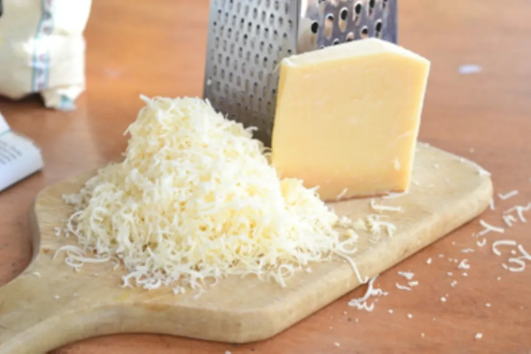 The Perfect Shred of parmesan cheese on a cutting board